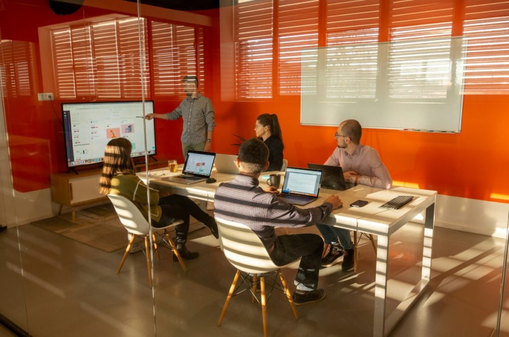 People meeting in a room regarding an IT project
