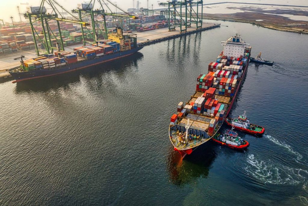 A large cargo ship leaving the docks