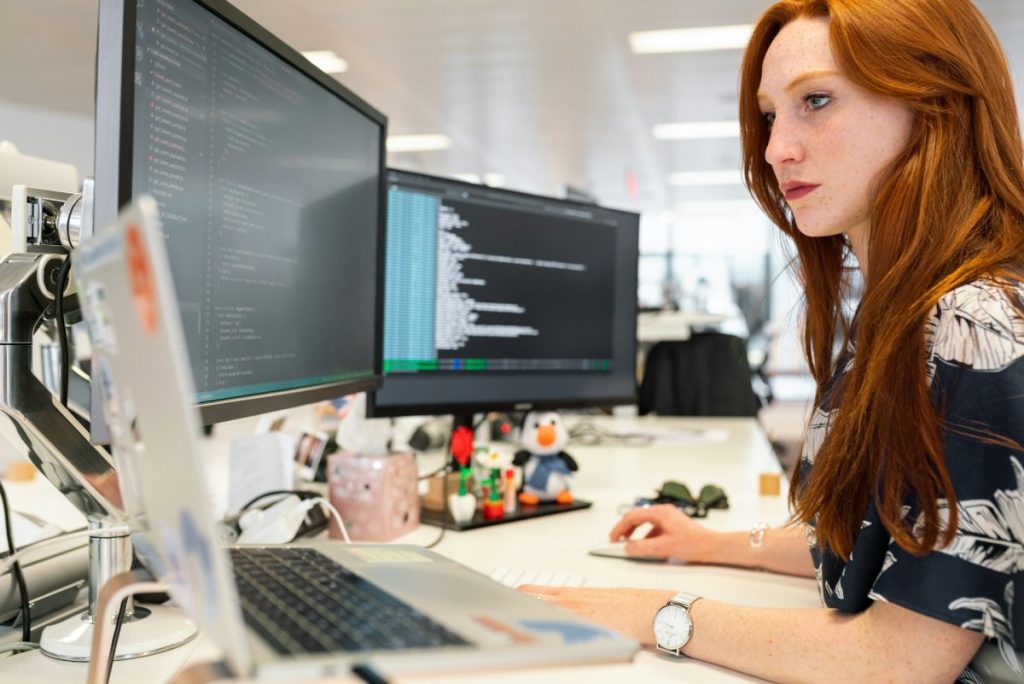 A woman programming a software
