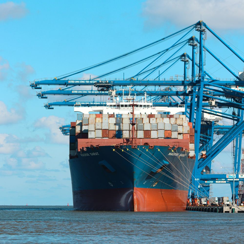 Large cargo ship being loaded